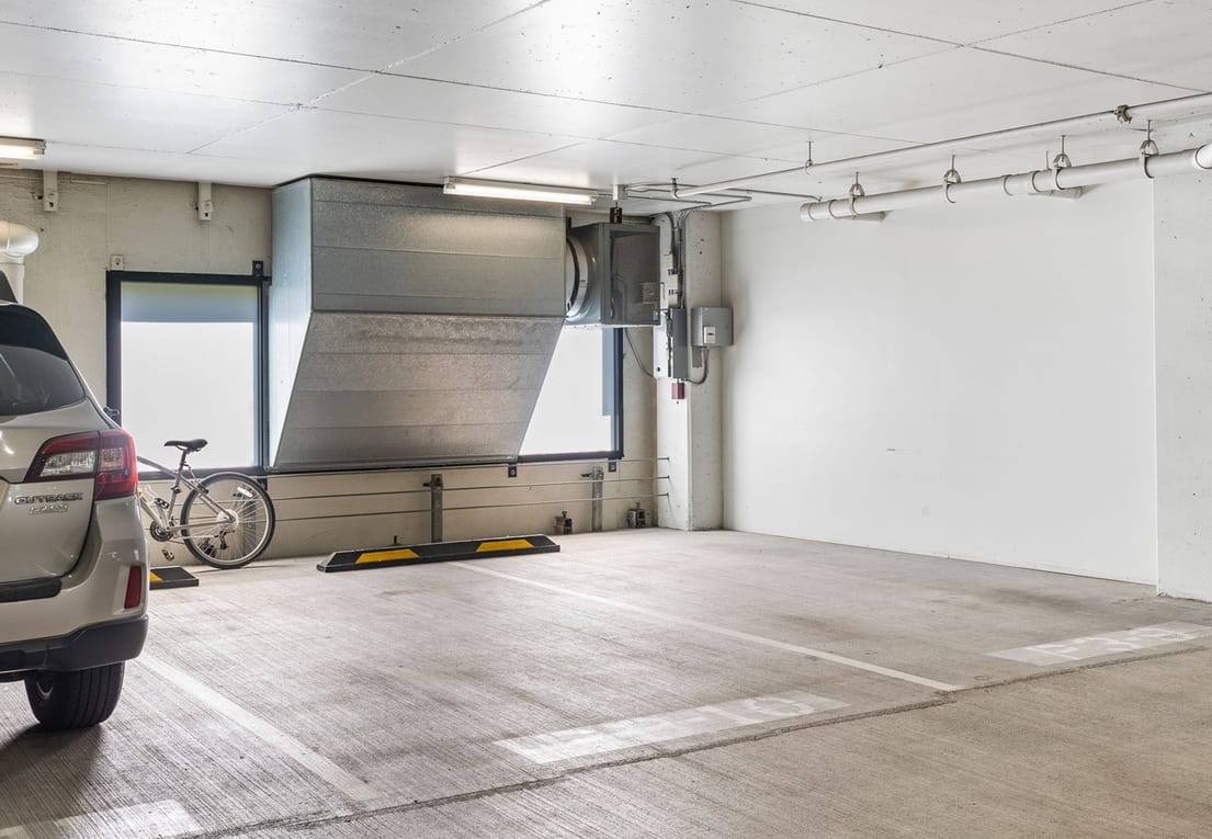 Secure underground garage parking with modern lighting and safety features